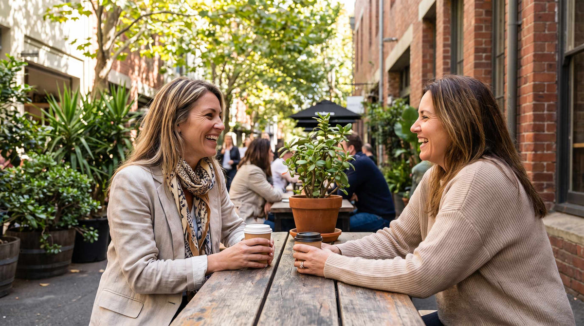 Australian woman enjoying caf with friend, confident despite light bladder leaks